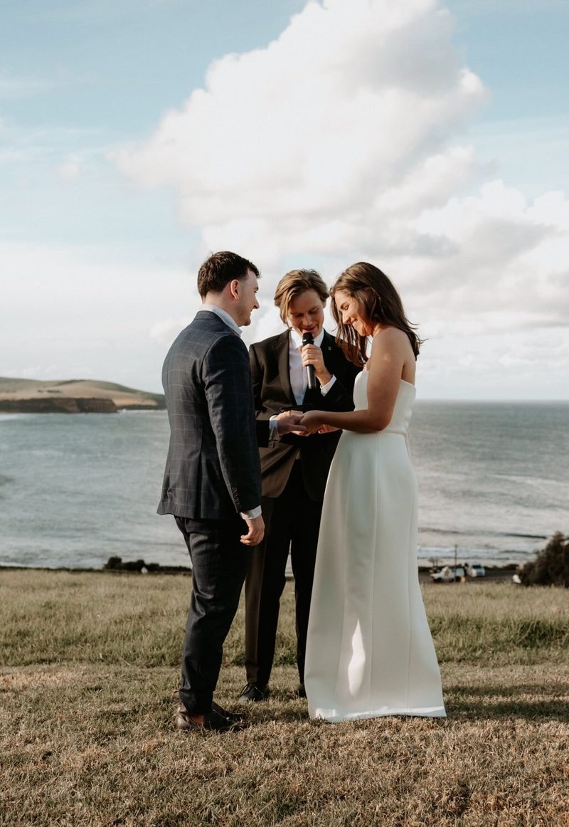 Brayden Wedd marrying a couple on a clifftop above the ocean