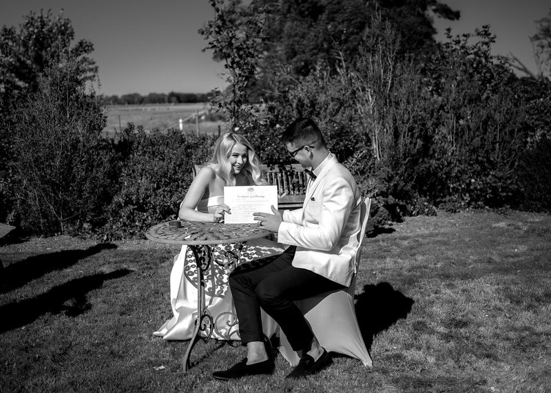 Signing the register on the lawn, in black and white