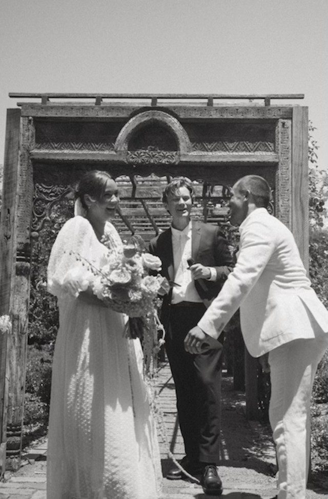 The couple with Brayden beneath the arch, in black and white